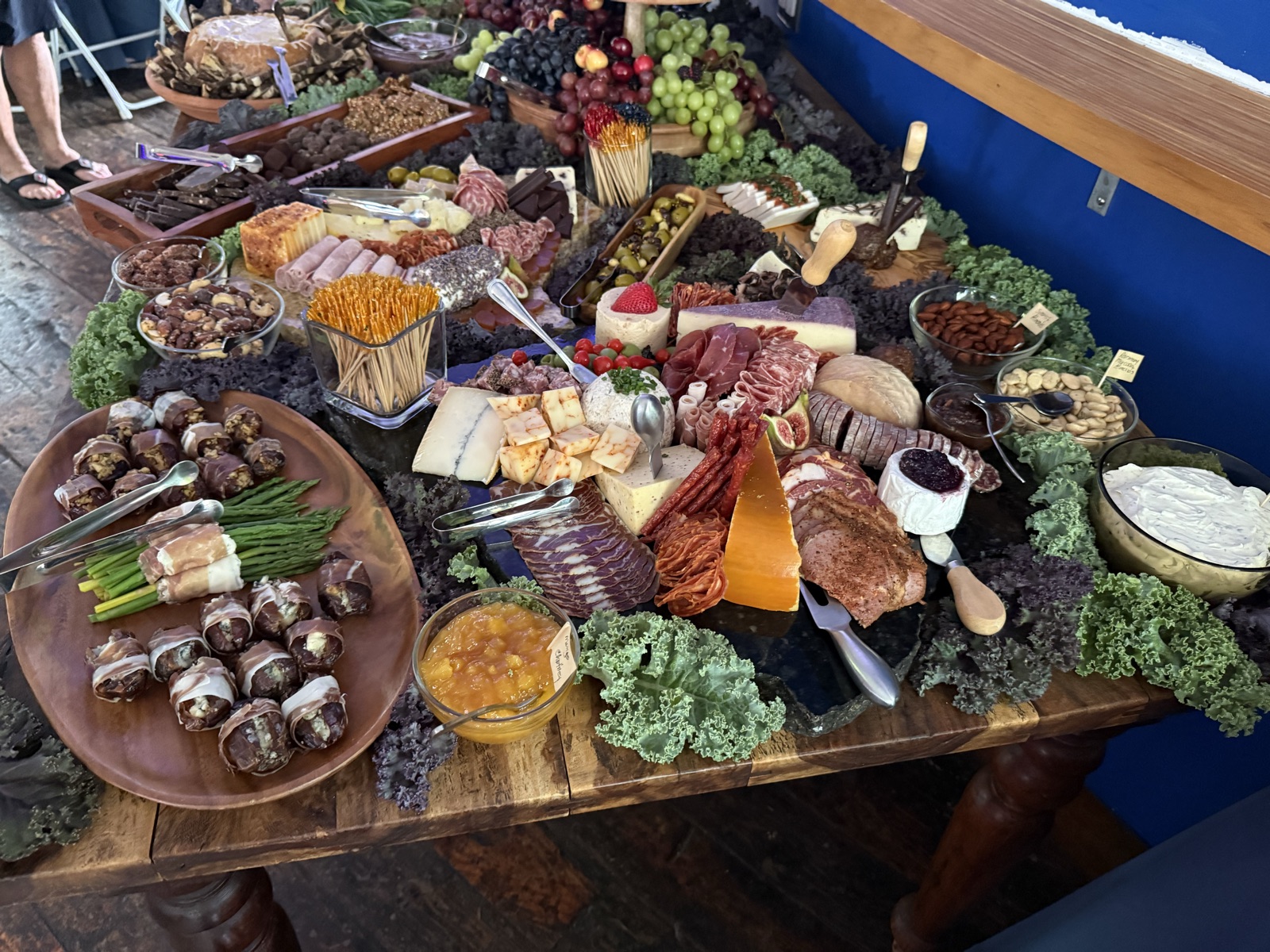 A grazing table spread of charcuterie, cheeses, and fruit by Anne's Catering